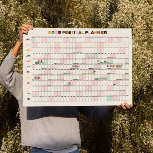 Person holding an A1 wall planner 2025 calendar with UK festival dates