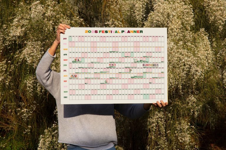Person holding an A1 wall planner 2025 calendar with UK festival dates